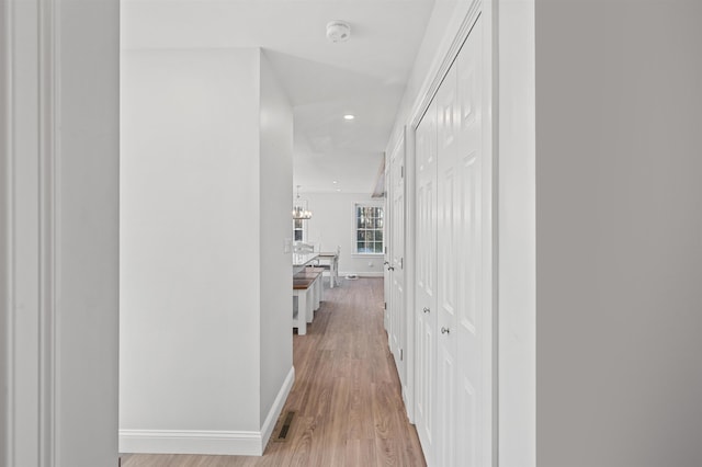 hallway with light wood-type flooring, visible vents, baseboards, and recessed lighting