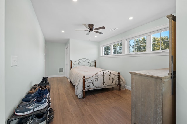 bedroom with recessed lighting, visible vents, baseboards, and wood finished floors