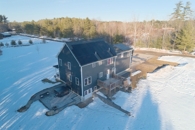 drone / aerial view featuring a wooded view