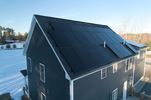 view of property exterior with solar panels