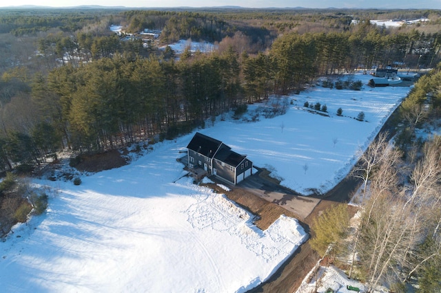 snowy aerial view with a view of trees