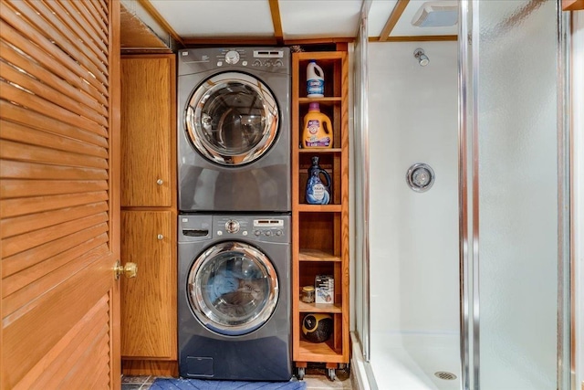 clothes washing area featuring stacked washer / dryer