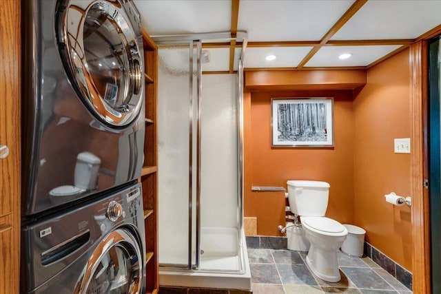 laundry area with baseboards, laundry area, recessed lighting, stacked washer and clothes dryer, and stone finish flooring