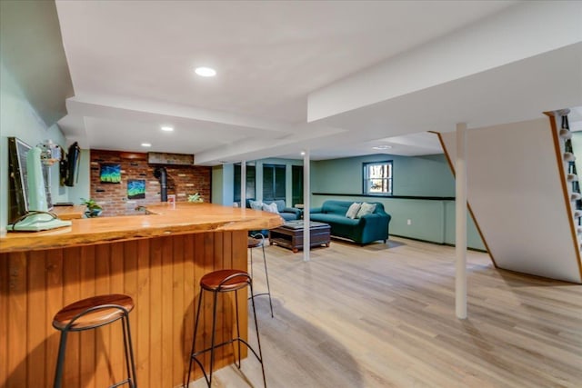 bar with recessed lighting, light wood-style floors, and indoor bar