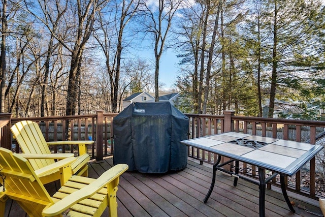 wooden terrace featuring a grill