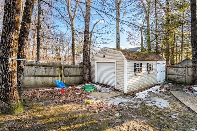 detached garage with fence and a shed