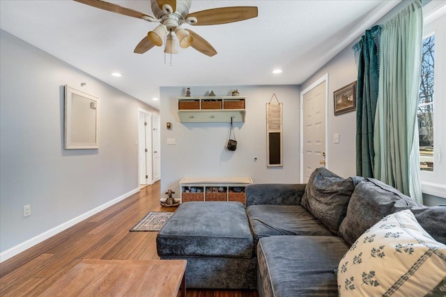 living room featuring recessed lighting, baseboards, wood finished floors, and a ceiling fan