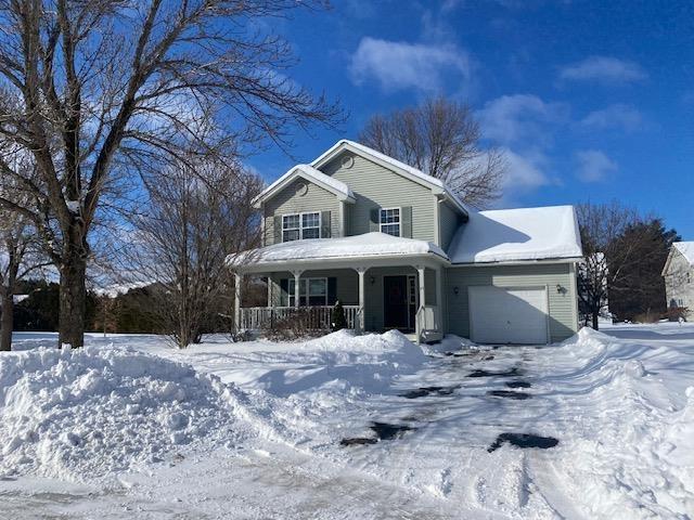 view of front of property featuring a porch and a garage