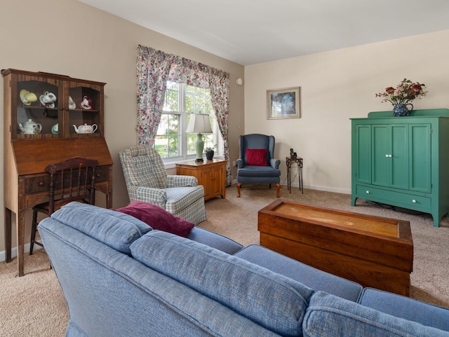 living room with baseboards and light carpet