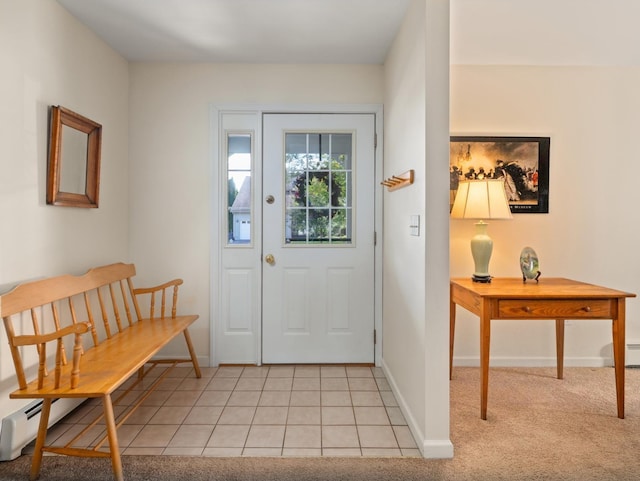 foyer entrance featuring light tile patterned floors, baseboards, and light carpet