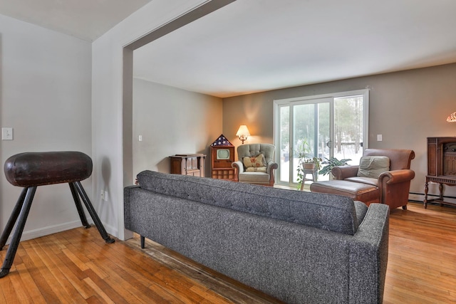 living area featuring baseboards and hardwood / wood-style flooring