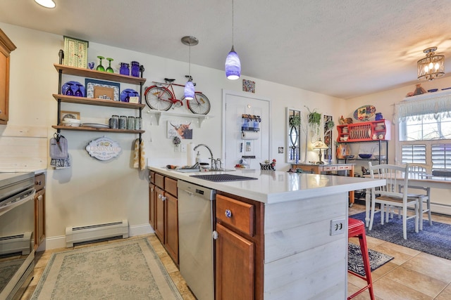 kitchen featuring light countertops, brown cabinets, a peninsula, stainless steel appliances, and a baseboard radiator