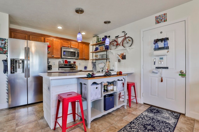 kitchen with light countertops, brown cabinets, appliances with stainless steel finishes, hanging light fixtures, and open shelves