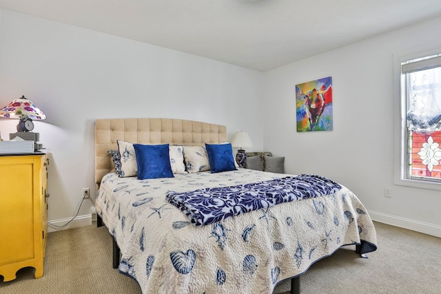 bedroom with carpet flooring and baseboards