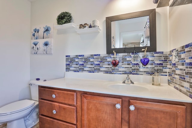 half bathroom featuring tasteful backsplash, toilet, and vanity