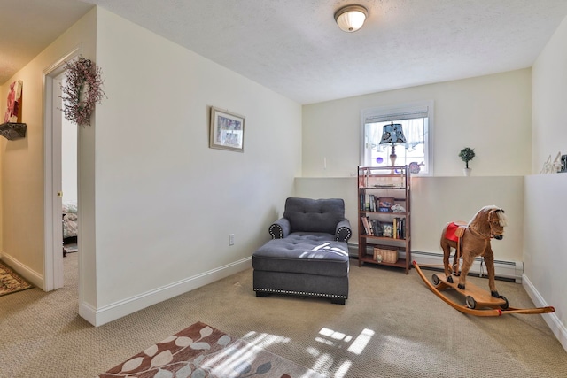 sitting room with carpet, baseboards, baseboard heating, and a textured ceiling