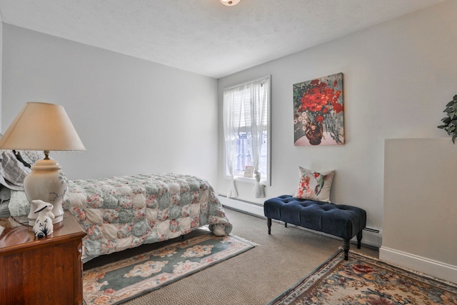 bedroom with carpet flooring, baseboards, and a textured ceiling