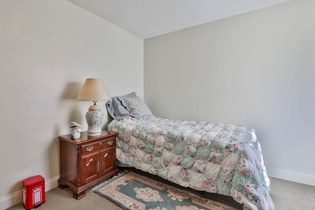 bedroom featuring light carpet and baseboards