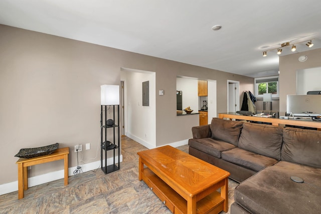 living area with electric panel and baseboards