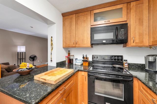 kitchen with glass insert cabinets, open floor plan, dark stone counters, brown cabinetry, and black appliances