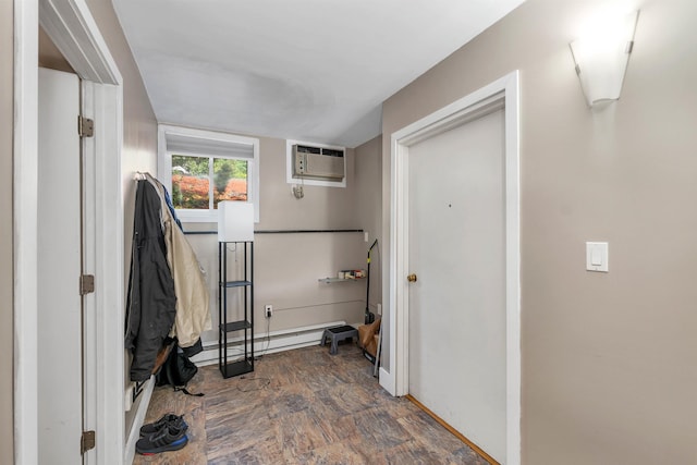 washroom featuring a baseboard heating unit and a wall mounted AC