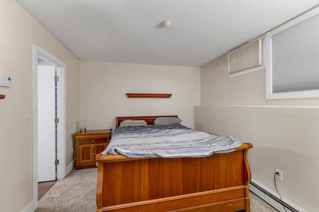 bedroom with a baseboard heating unit, baseboards, light colored carpet, and a textured ceiling