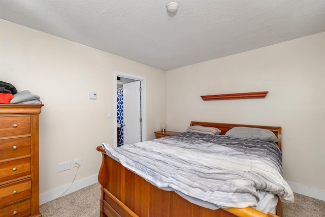 bedroom with baseboards, carpet floors, and a textured ceiling