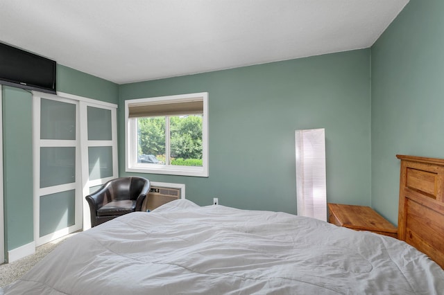 carpeted bedroom with a wall mounted AC