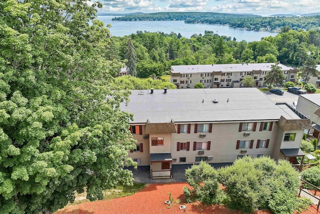 birds eye view of property with a water view and a view of trees