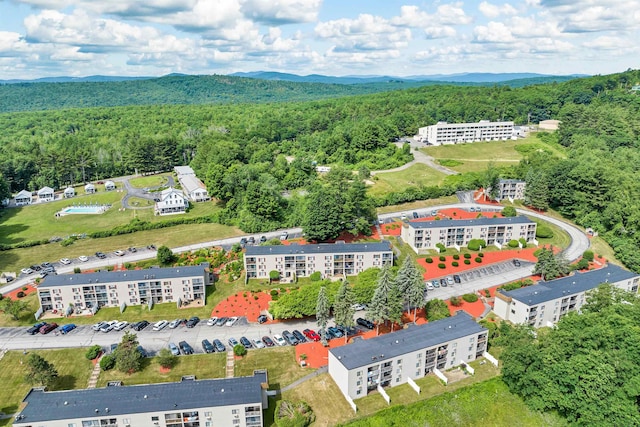 birds eye view of property featuring a mountain view and a forest view