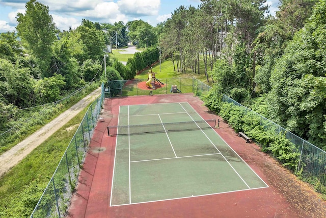 view of tennis court featuring fence