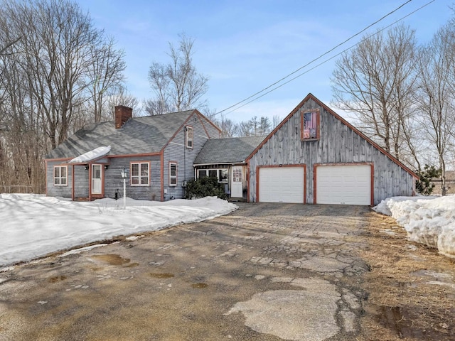 view of front of home featuring a chimney and driveway