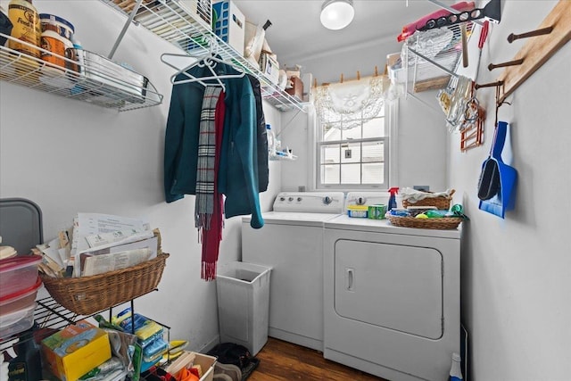 clothes washing area featuring laundry area, independent washer and dryer, and wood finished floors