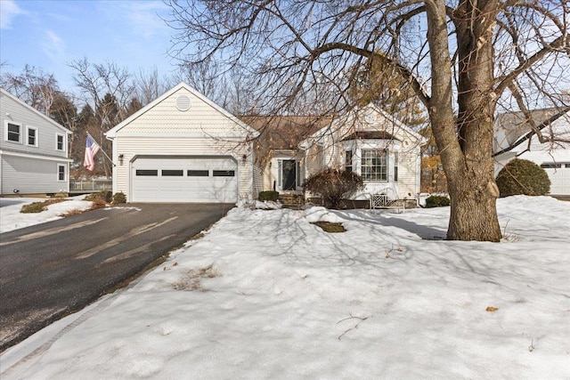 ranch-style home featuring a garage and driveway