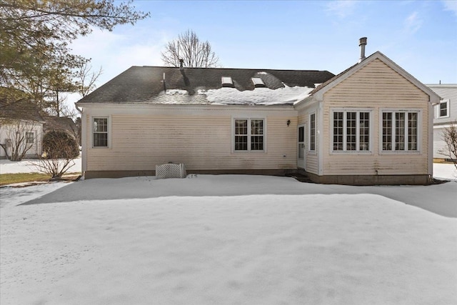 view of snow covered rear of property