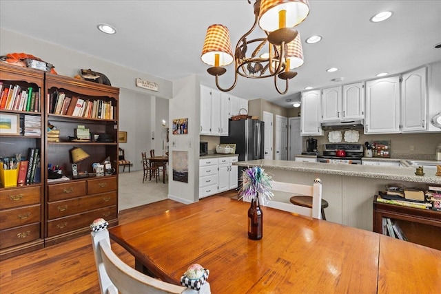 dining area featuring a notable chandelier and recessed lighting