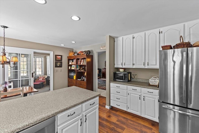 kitchen with recessed lighting, stainless steel appliances, dark wood-type flooring, white cabinets, and decorative light fixtures