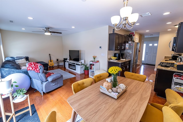 dining space with recessed lighting, visible vents, and wood finished floors