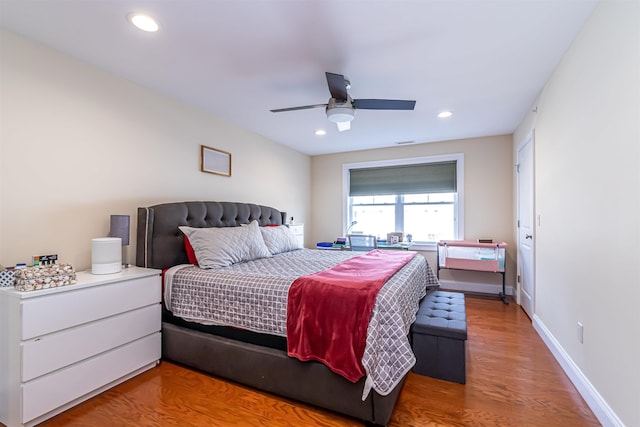 bedroom with recessed lighting, ceiling fan, baseboards, and wood finished floors