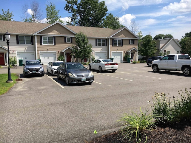 view of front of home featuring uncovered parking and a residential view