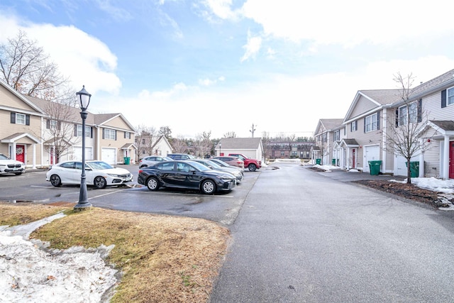 view of road with a residential view and street lighting