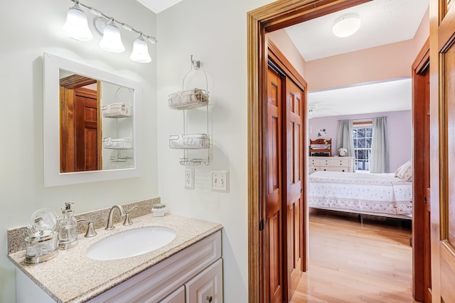 bathroom featuring vanity, ensuite bath, and wood finished floors