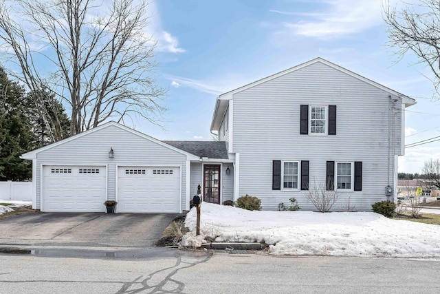 traditional-style house with aphalt driveway and an attached garage