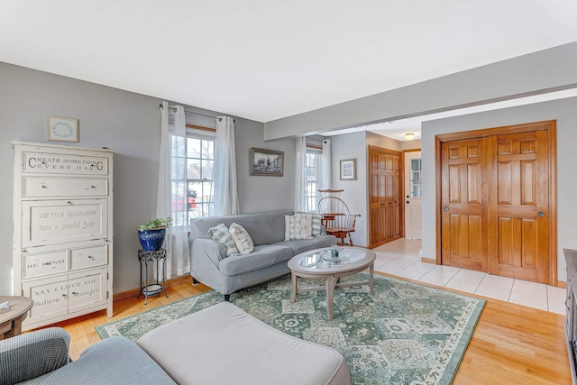 living room featuring baseboards and light wood finished floors