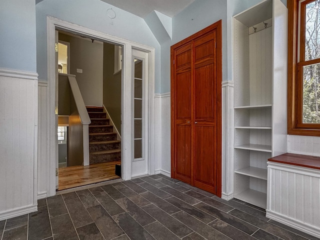 interior space with stairs, plenty of natural light, wainscoting, and radiator heating unit