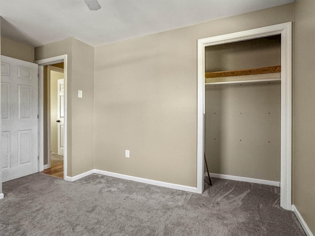 unfurnished bedroom with a closet, baseboards, and carpet floors