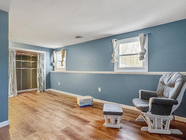 living area featuring baseboards and wood finished floors