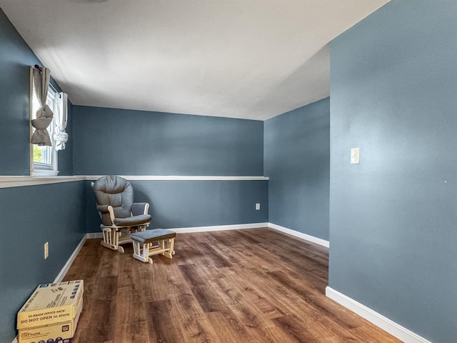 unfurnished room featuring baseboards and wood finished floors