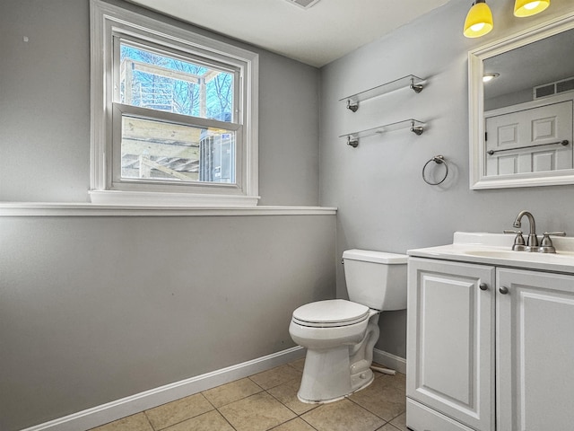 half bathroom with tile patterned flooring, visible vents, toilet, and baseboards