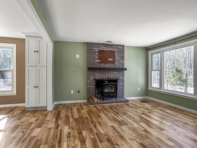 unfurnished living room featuring wood finished floors and baseboards